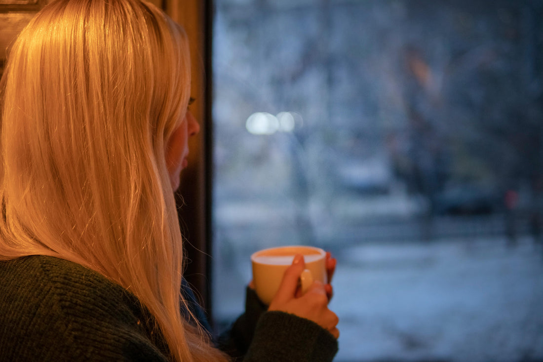 Women in winter sipping coffee