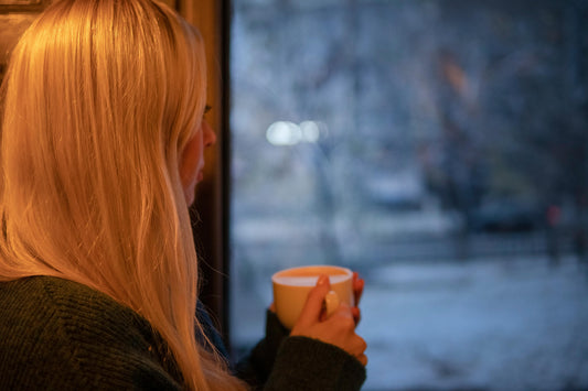 Women in winter sipping coffee