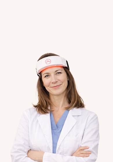 Portrait of a clinician wearing a CERA System wearable neurostimulation device, optimized for mobile display.