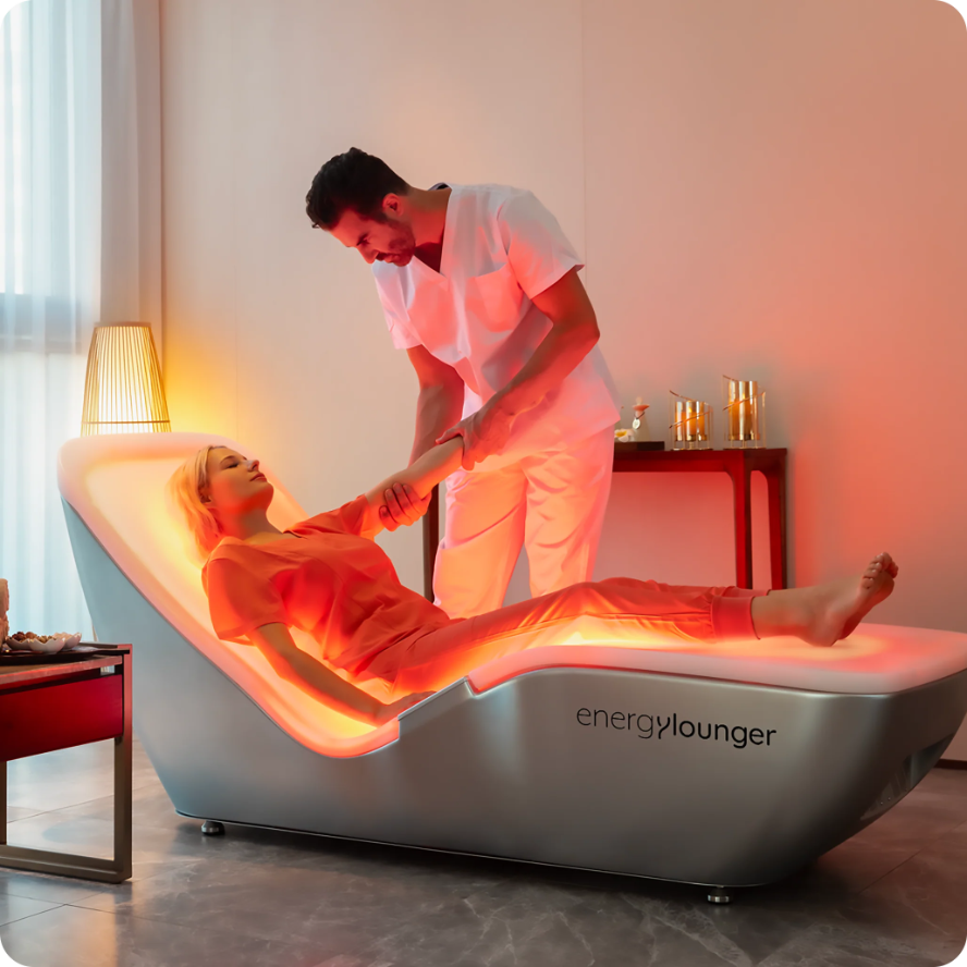 CeraThrive EnergyLounger Wellness Platform for professional and personal use, featuring a client receiving full-body red and near-infrared light therapy for pain relief, immunity, and inflammation reduction.