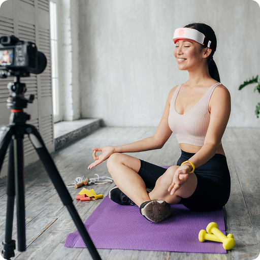 CeraThrive Wellness Influencer recording a video while meditating with the CERA red light therapy device, appealing to health coaches and functional medicine practitioners.